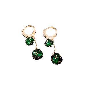 Elegant gold earrings with emerald green faceted stone pendants on a white background