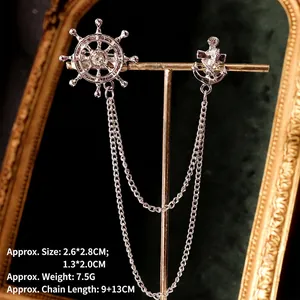 Detail of vintage silver anchor and ship wheel collar brooch with tassel chains