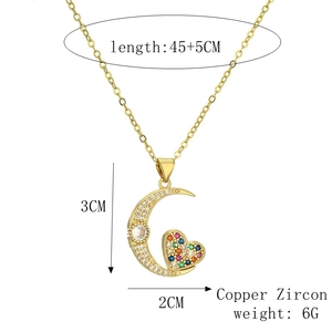Detail view of gold heart and moon pendant with dimensions 3x2cm and length 45+5cm