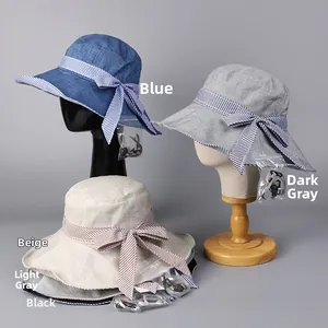 Detail of striped bow sun hat showing breathable cotton linen fabric and detachable wind cord