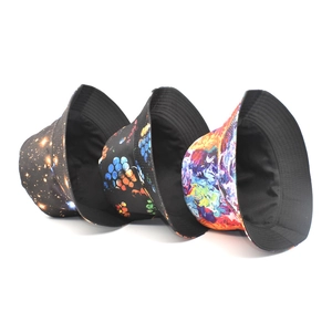 Detailed stack of printed canvas bucket hats featuring starry sky and oil painting patterns