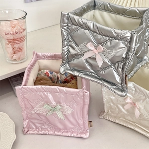 Close-up of quilted PU storage baskets in silver pink and white with lace bows