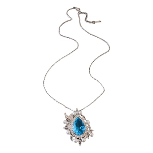 Elegant blue water drop gemstone necklace with pearl surround on a silver chain