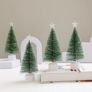 Detail of four flocked mini Christmas trees with LED fairy lights and star toppers