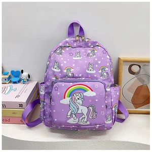 Detail view of purple school bag with unicorn and rainbow prints in a cozy setting