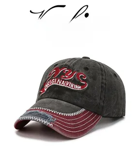 Close-up of NYC embroidery on distressed washed denim baseball cap with frayed brim detail