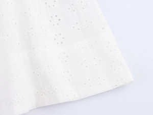 Macro shot of white Broderie Anglaise hollow embroidery with floral patterns