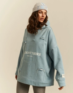 Detail of light blue oversized hoodie featuring distressed rips and FOMO DEPT. lettering