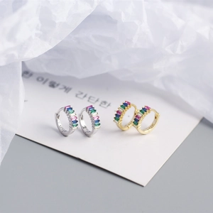 Macro detail of S925 silver hoop earrings featuring baguette-cut colorful zircon stones