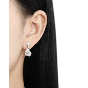Irregular lava texture S925 sterling silver stud earrings with diamond accents on a model