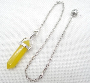 Detail view of a yellow crystal hexagonal pendulum pendant with a fine silver metal chain