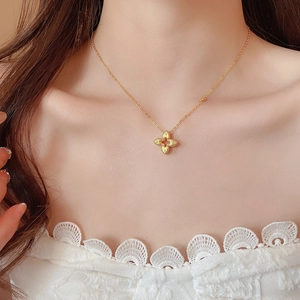 Golden clover pendant necklace with zircon hollow flower design on elegant female neck