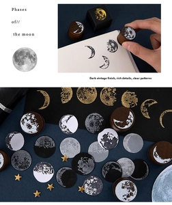 Detailed view of vintage moon phase wooden stamps and moon stickers with gold stars