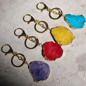 Detail of colorful irregular natural agate stone keychains in blue, yellow, red and purple