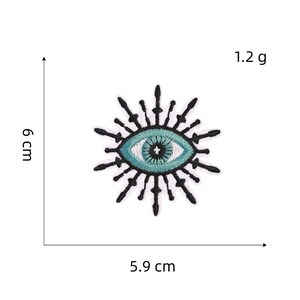 Detailed size view of evil eye embroidery patch with measurements 6 cm by 5.9 cm