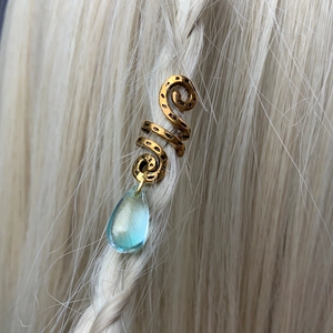 Gold spiral dreadlock accessory with a blue teardrop pendant for braided hair styling