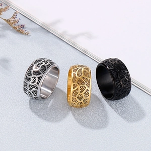 Detailed view of three vintage drum-shaped men's rings with unique honeycomb textures
