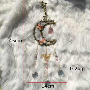 Detail view of crescent moon dream catcher with pink stone and hanging crystal balls