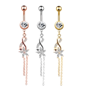 Detailed view of belly rings in rose gold, silver, and gold with crystal flower tassels
