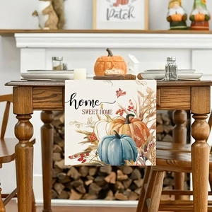 Close-up of harvest pumpkins and home SWEET HOME text on autumn table runner