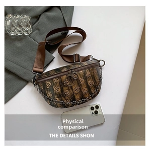 Macro detail of dark brown skull pattern chest bag with vintage chain and wood grain texture