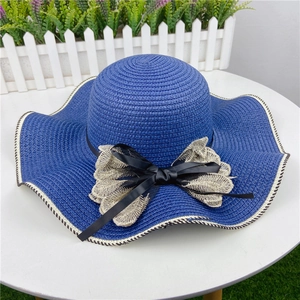 Blue straw sun hat with wavy brim, lace flower decoration and black ribbon for summer