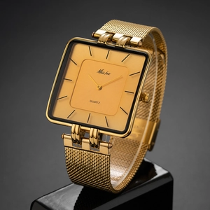 Close-up of golden square quartz watch with premium metal mesh strap on display