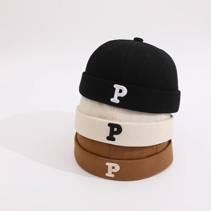 Detailed embroidery of letter P on cotton canvas skull caps in black, beige and brown