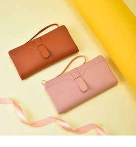 Detail view of women's long wallet, PU leather clutch purse with wrist strap and card slots.