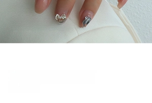 Detailed macro view of bowknot rhinestones and rectangular crystal nail art charms