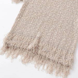 Women's beige knit sleeveless top with fringe tassel hem and rough textured fabric