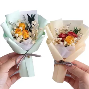 Mini dried flower bouquets with roses and baby's breath in elegant gift wrapping