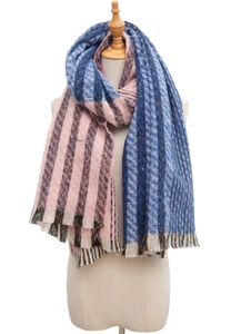 Detailed close-up of striped multi-color scarf with fringe tassels on model