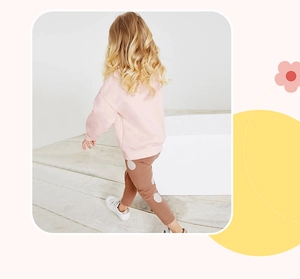 Pink fleece sweatshirt and brown polka dot pants set worn by a young girl