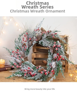 Detail of a snow-covered Christmas wreath with red berries, pine needles and pine cones