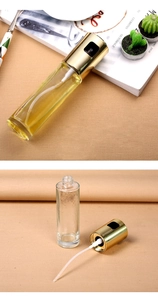 Disassembled view showing gold spray head, glass bottle, and straw components