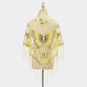 Detail of yellow lace shawl featuring intricate butterfly embroidery and long hanging tassels