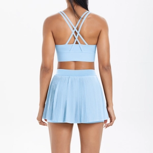 Light blue yoga set featuring a cross-back sports bra and pleated tennis skirt outfit