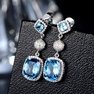 Luxury silver drop earrings with square blue sapphire stones and diamond halo setting