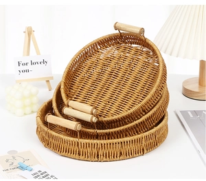 Three-piece set of woven fruit trays with wooden handles in a stackable round design
