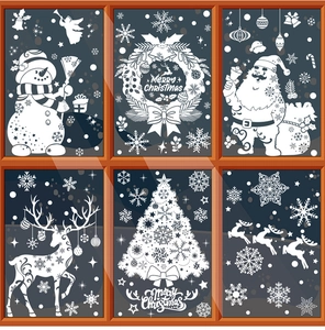 Detail view of white Christmas window stickers with snowman, Santa, and elk on glass