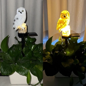 Solar powered white owl garden light with wood base and warm LED stake lighting
