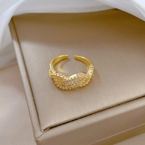 Detailed view of adjustable gold-plated twisted ring with pavé-set shimmering crystals