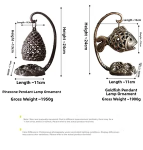 Detailed view of vintage cast iron pinecone and goldfish candle holders with dimensions