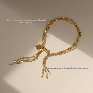 Detailed close-up of a three-layer gold-plated titanium steel bracelet with shiny sequins