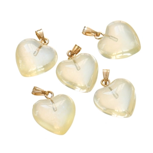Detailed view of five heart-shaped acrylic pendants in pale yellow with gold metal loops