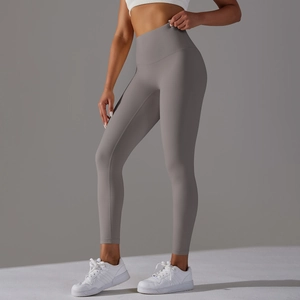 Close-up of seamless high-waisted grey yoga pants showing stretch fabric and body shaping
