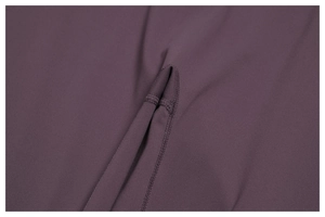 Detailed close-up of double-stitched seams on high-elasticity dark purple yoga fabric