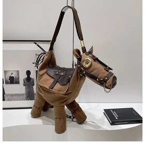 Detailed view of horse-shaped canvas shoulder bag with brown leather accents and metal hardware