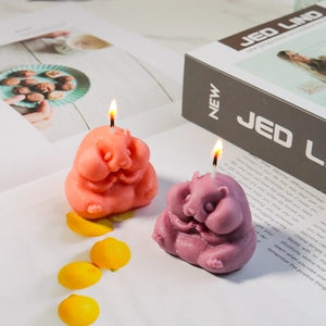 Detailed view of two cute marmot scented candles in orange and purple pastel tones